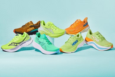 seven best running shoes of the year stacked on top of boxes